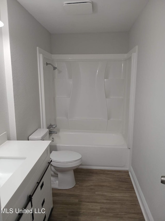 full bathroom with vanity, shower / bathing tub combination, hardwood / wood-style flooring, and toilet