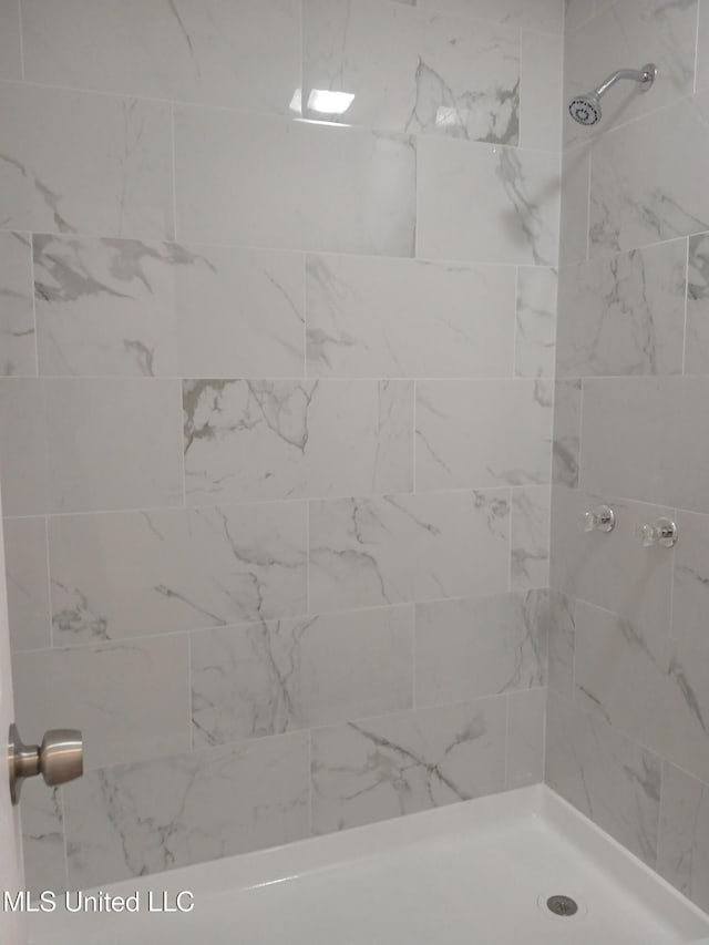 bathroom with tiled shower