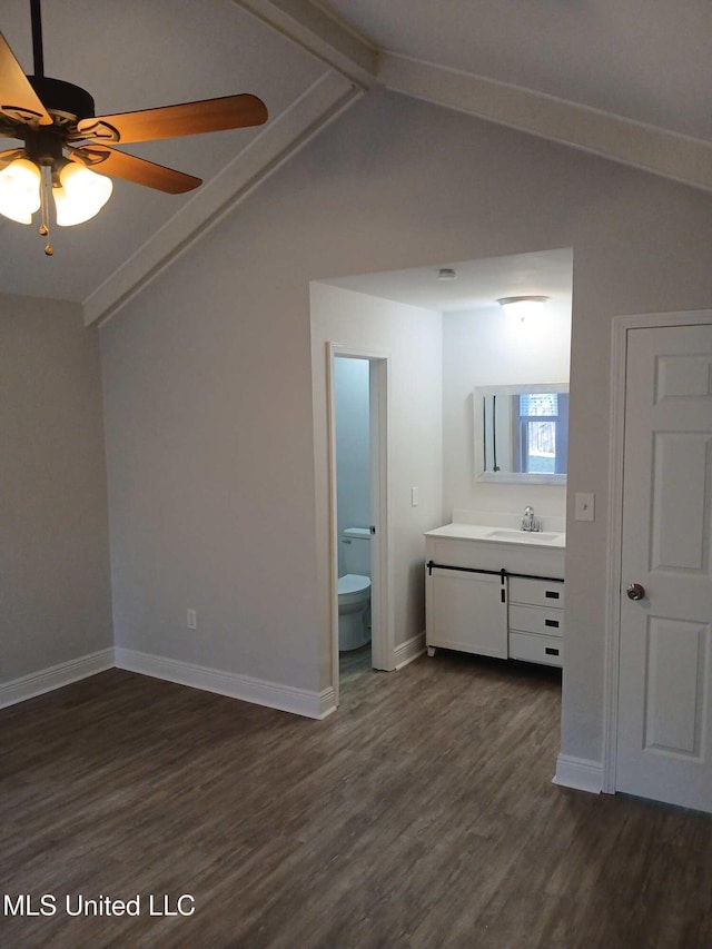 interior space featuring ceiling fan, vaulted ceiling with beams, hardwood / wood-style floors, vanity, and toilet