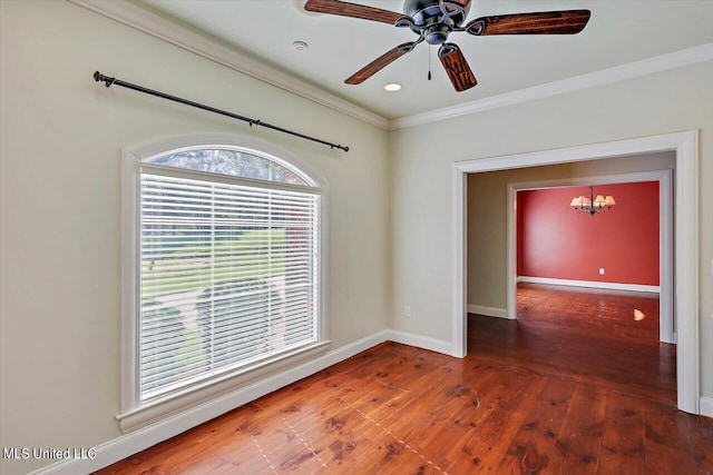 empty room featuring crown molding, dark hardwood / wood-style floors, and ceiling fan with notable chandelier