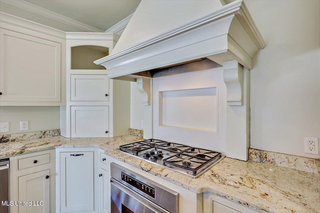 kitchen featuring ornamental molding, premium range hood, appliances with stainless steel finishes, and white cabinetry