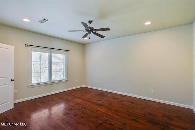 empty room featuring dark hardwood / wood-style floors and ceiling fan