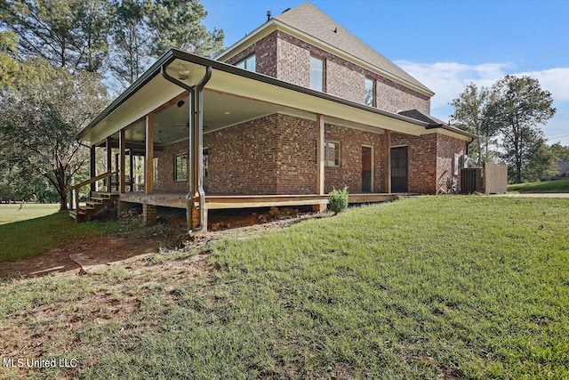 back of property featuring central AC and a yard