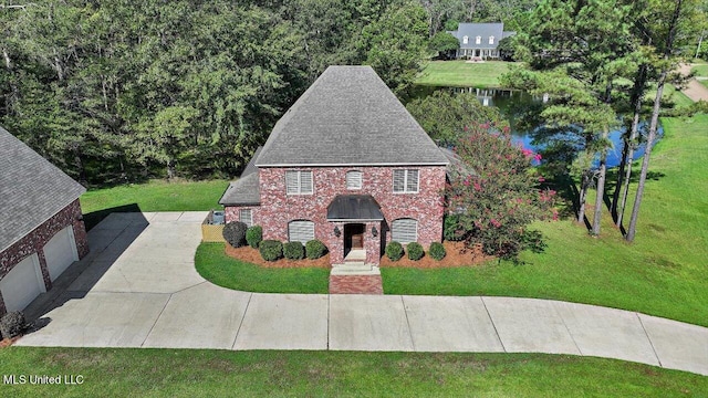 view of front of home with a garage and a front lawn