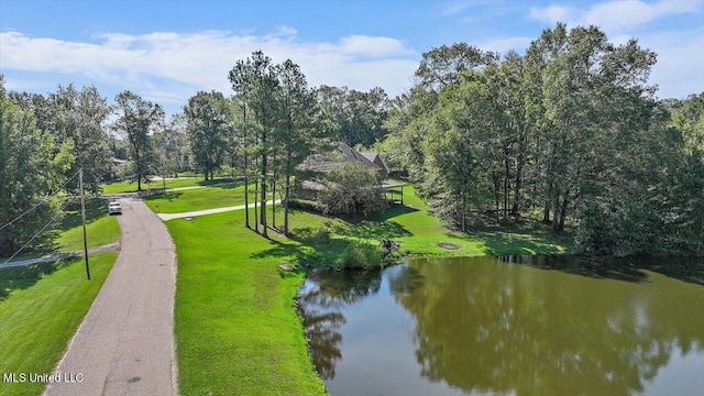 surrounding community featuring a yard and a water view