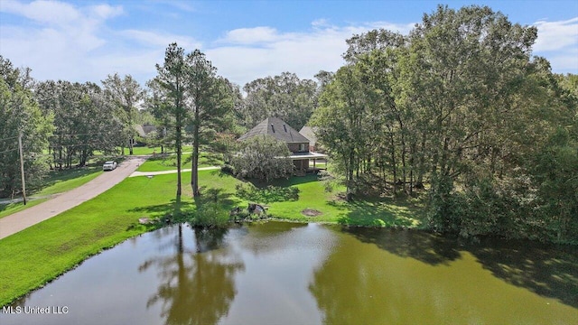 exterior space featuring a water view and a lawn