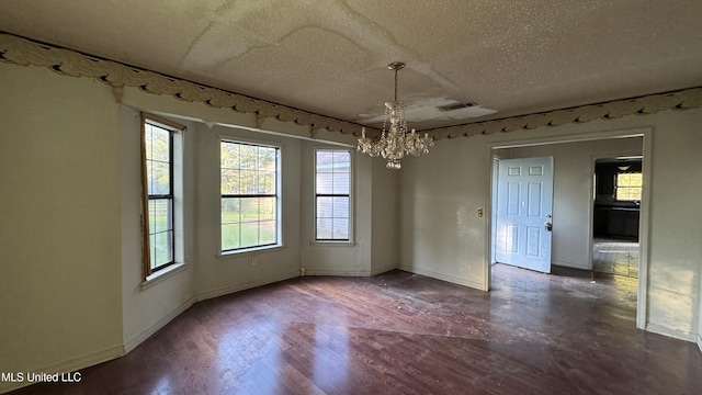 unfurnished dining area with hardwood / wood-style floors, a notable chandelier, and a textured ceiling