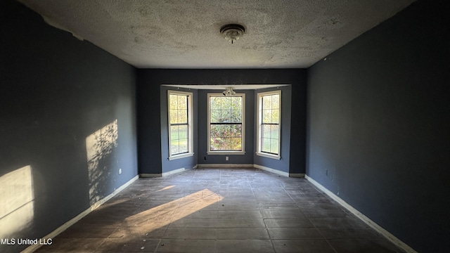 empty room with a textured ceiling