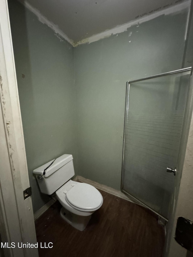 bathroom featuring wood-type flooring and toilet