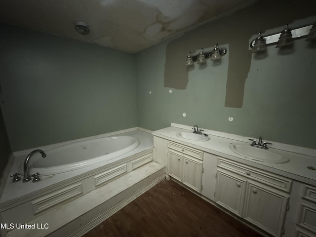 bathroom featuring hardwood / wood-style floors, vanity, and a bath