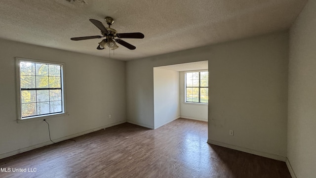 spare room with ceiling fan, hardwood / wood-style floors, a healthy amount of sunlight, and a textured ceiling