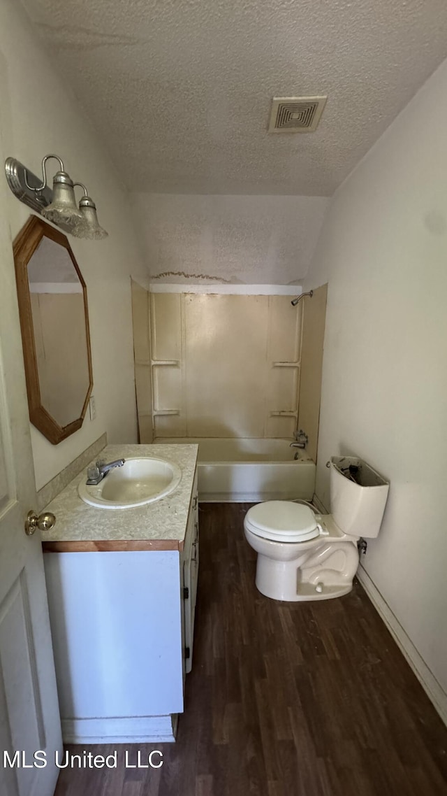 full bathroom with vanity, shower / bath combination, a textured ceiling, and hardwood / wood-style flooring