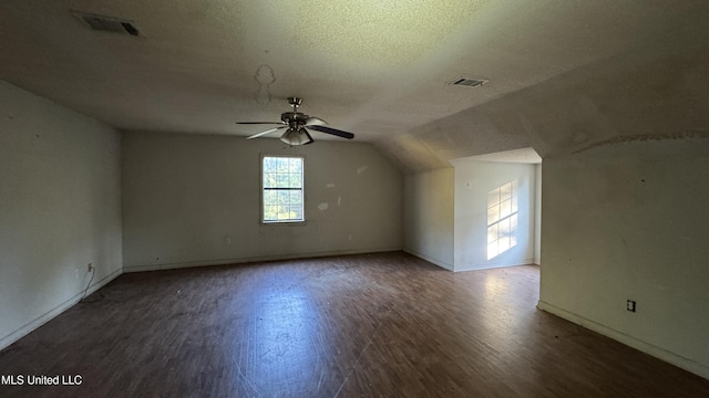 additional living space featuring ceiling fan, dark hardwood / wood-style flooring, a textured ceiling, and vaulted ceiling