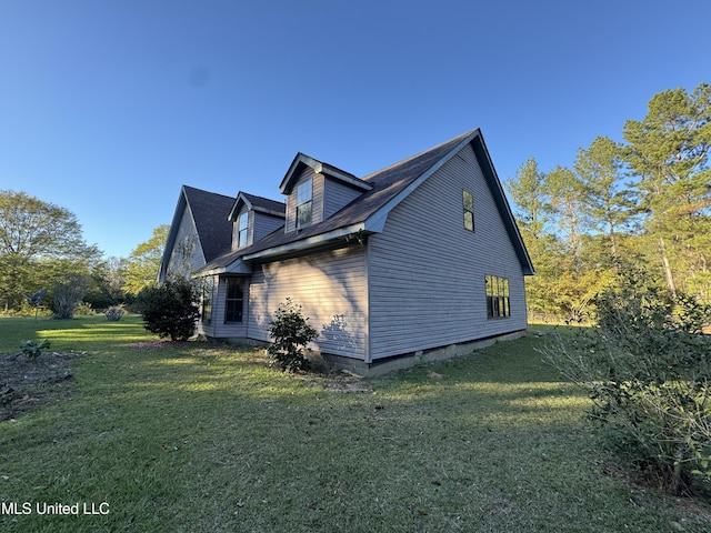 view of side of home featuring a lawn