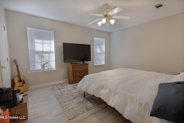 bedroom with ceiling fan and light hardwood / wood-style flooring