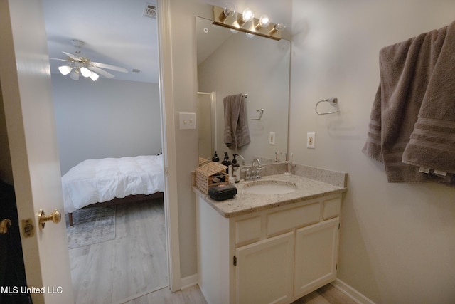 bathroom featuring hardwood / wood-style flooring, ceiling fan, and vanity