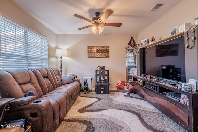 living room featuring carpet and ceiling fan