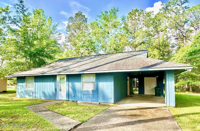 6 Dogwood Cir, Diamondhead, MS 39525 - view of front of property featuring concrete driveway, a shingled roof, a carport, and a front yard