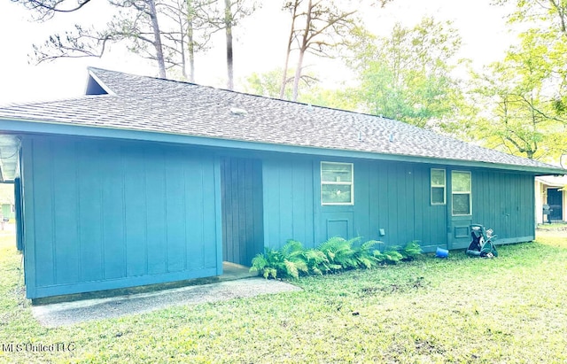 6 Dogwood Cir, Diamondhead, MS 39525 - view of home's exterior with a shingled roof and a lawn