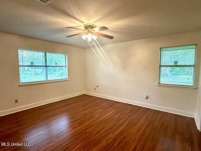 6 Dogwood Cir, Diamondhead, MS 39525 - unfurnished room featuring dark wood-style floors, a ceiling fan, and baseboards
