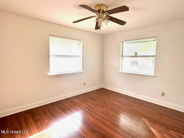 6 Dogwood Cir, Diamondhead, MS 39525 - spare room with baseboards, dark wood-style floors, and ceiling fan