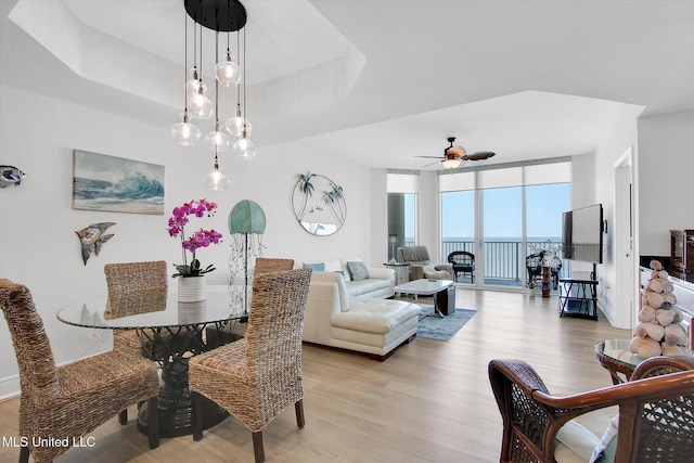 2668 Beach Blvd Unit 1405, Biloxi, MS 39531 - dining space with light wood-style flooring, a ceiling fan, floor to ceiling windows, and a raised ceiling