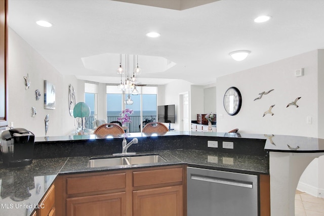2668 Beach Blvd Unit 1405, Biloxi, MS 39531 - kitchen with stainless steel dishwasher, a sink, brown cabinets, light tile patterned floors, and dark stone counters