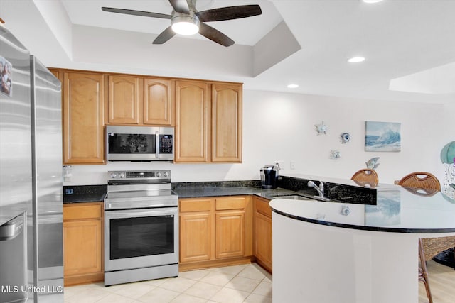 2668 Beach Blvd Unit 1405, Biloxi, MS 39531 - kitchen featuring stainless steel appliances, a peninsula, a sink, ceiling fan, and a kitchen breakfast bar