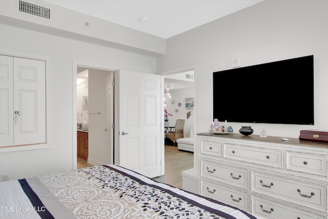 2668 Beach Blvd Unit 1405, Biloxi, MS 39531 - bedroom featuring light wood finished floors and ensuite bathroom