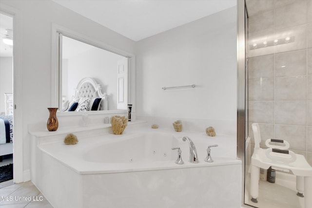 2668 Beach Blvd Unit 1405, Biloxi, MS 39531 - ensuite bathroom featuring a jetted tub and tile patterned flooring