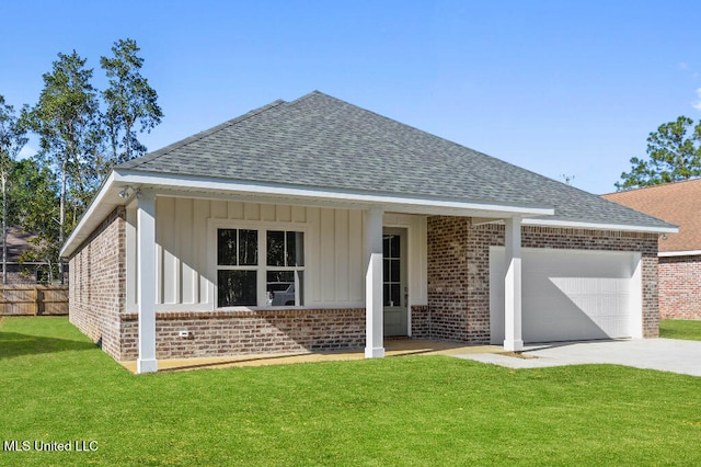 view of front of house featuring a front lawn and a garage