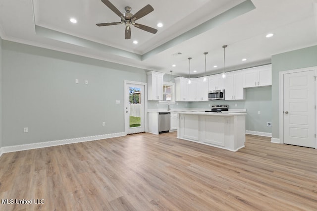 kitchen featuring pendant lighting, light hardwood / wood-style floors, white cabinetry, and a kitchen island