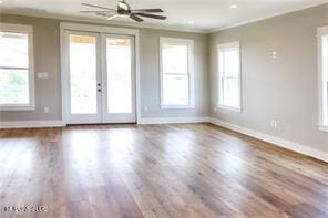 0 N Daytona Dr, Pearlington, MS 39572 - unfurnished living room featuring ornamental molding, wood finished floors, ceiling fan, and french doors