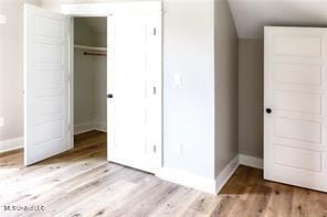 0 N Daytona Dr, Pearlington, MS 39572 - unfurnished bedroom featuring a closet and wood finished floors