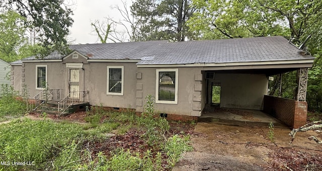 409 Houston Ave, Jackson, MS 39209 - view of front of property with crawl space, an attached carport, a shingled roof, stucco siding, and concrete driveway