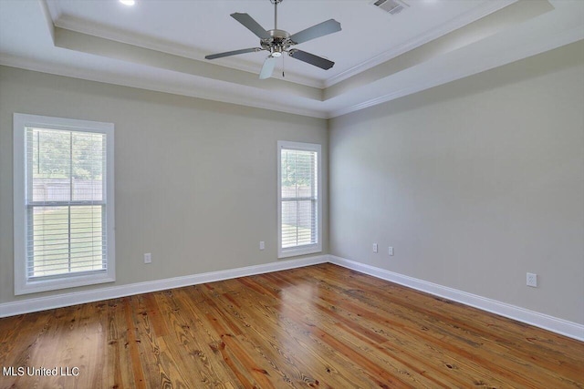 unfurnished room featuring ornamental molding, wood-type flooring, and plenty of natural light