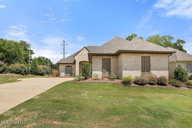 french country home with a front lawn