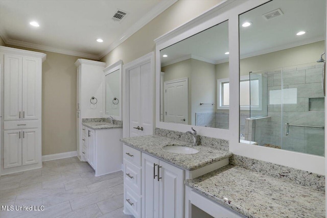 bathroom with a shower with door, vanity, ornamental molding, and tile patterned flooring