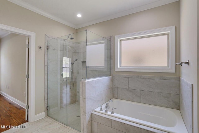 bathroom featuring hardwood / wood-style floors, crown molding, and plus walk in shower