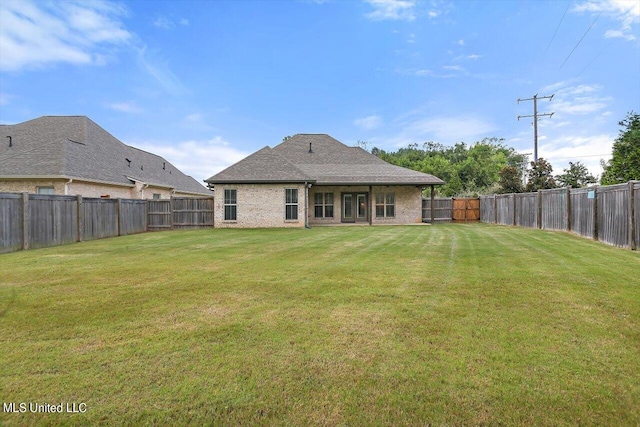 back of house featuring a lawn