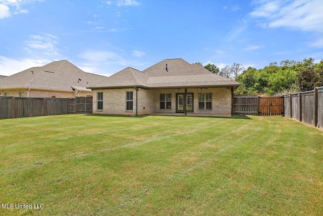 back of property featuring a lawn