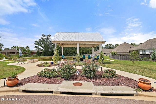 view of property's community with a patio area and a lawn