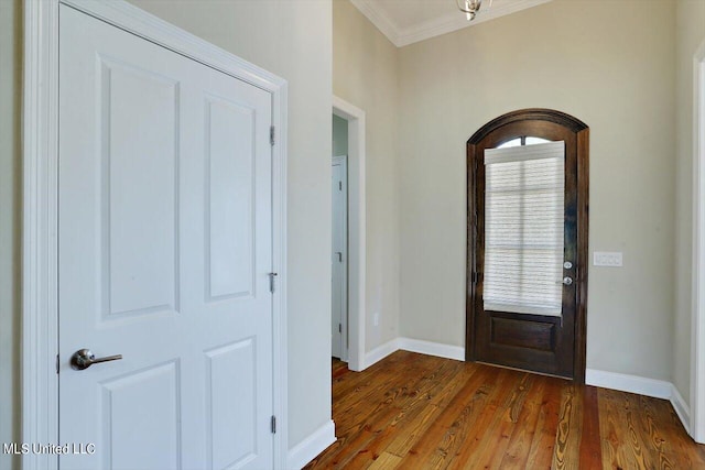 entryway featuring crown molding and dark hardwood / wood-style flooring