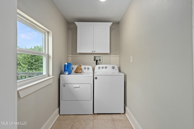 4113 Blue Jay St, Bay Saint Louis, MS 39520 - clothes washing area with independent washer and dryer, cabinets, and light tile patterned flooring