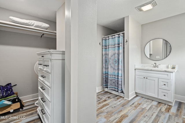 4113 Blue Jay St, Bay Saint Louis, MS 39520 - bathroom with vanity, curtained shower, and wood-type flooring