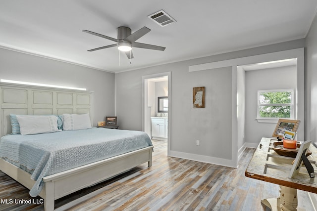 4113 Blue Jay St, Bay Saint Louis, MS 39520 - bedroom featuring ceiling fan, ornamental molding, connected bathroom, and light wood-type flooring