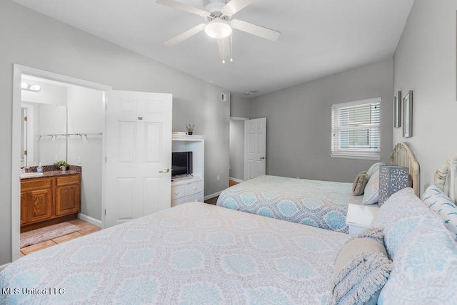 bedroom with sink, light wood-type flooring, a closet, ceiling fan, and lofted ceiling