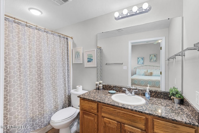 bathroom with toilet and vanity