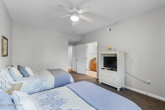 bedroom with dark carpet, connected bathroom, and ceiling fan