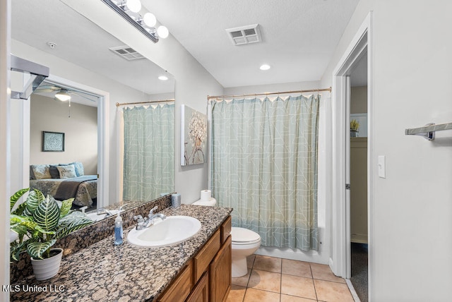 full bathroom featuring toilet, tile patterned flooring, ceiling fan, vanity, and shower / bathtub combination with curtain